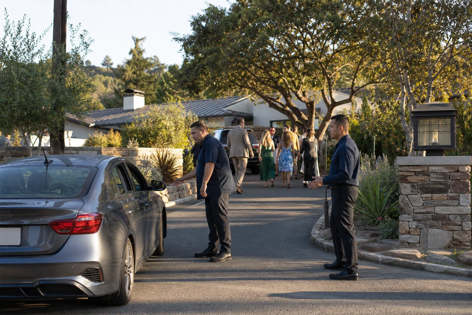 Valet attendants welcoming wedding guests at a South Bay foothill property in direct light